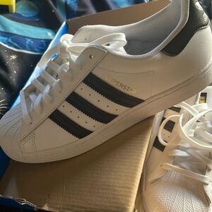 Adidas original shoes. White with black stripes. Size 7.5 in men’s 9.5 in women